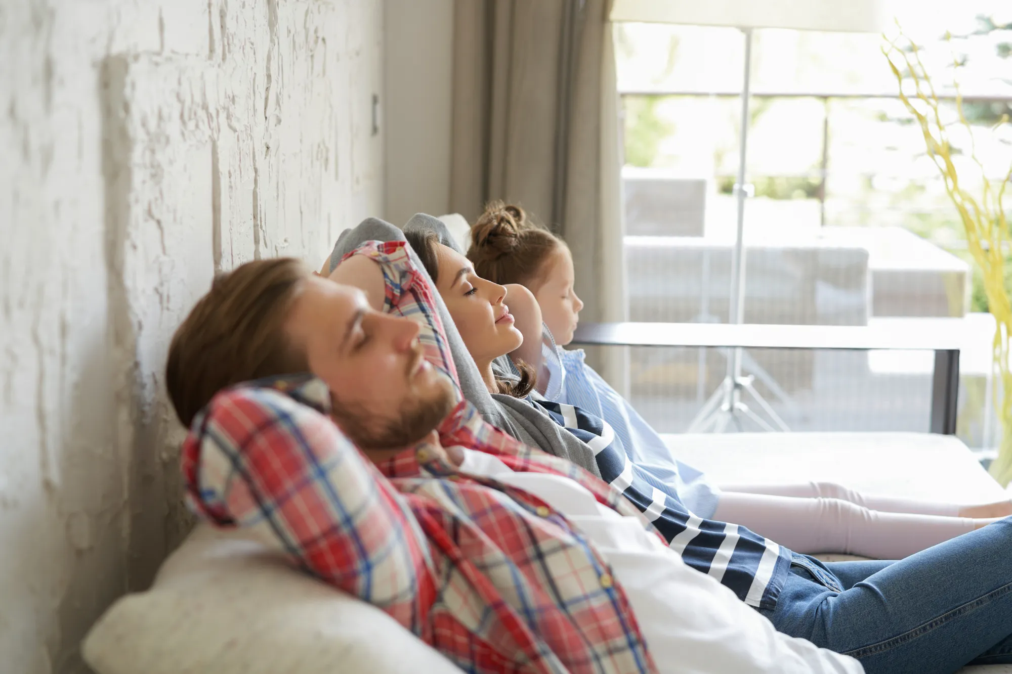 Happy family relaxing comfortably at home after insulation upgrades