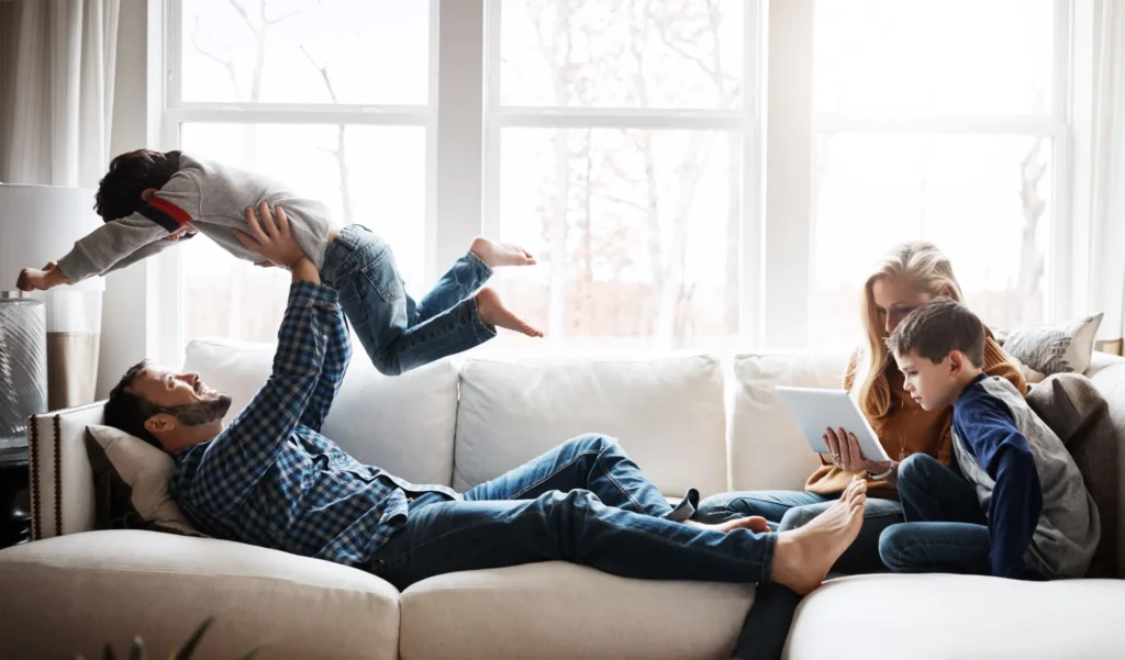 Happy Texas family enjoying a comfortable living room after home weatherization improvements