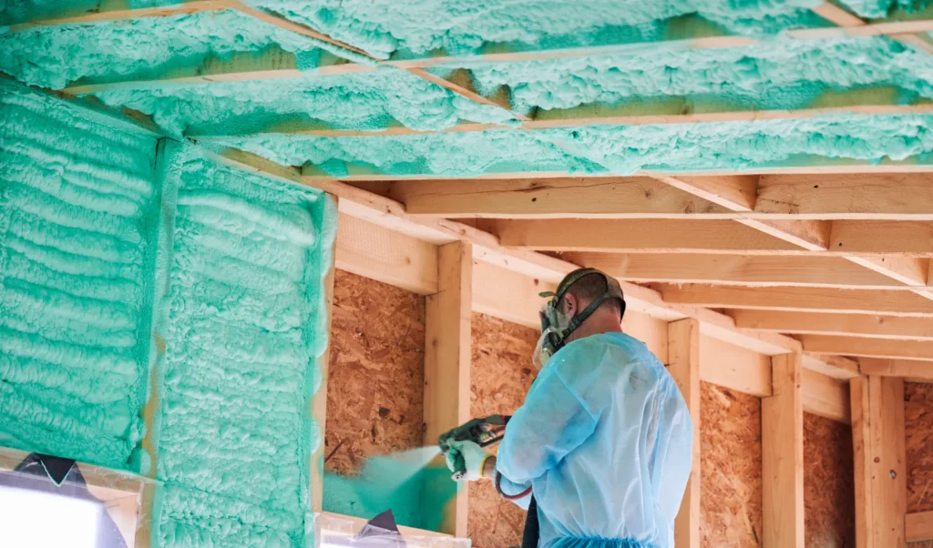 Technician applying spray foam insulation inside a Rockwall Texas home