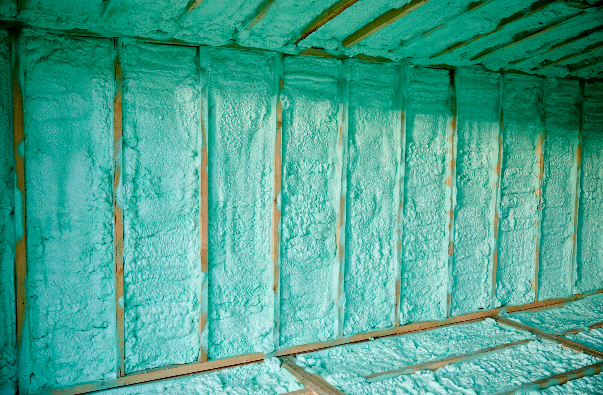 Technician applying spray foam insulation in a North Texas home attic